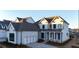 Two-story home with white siding, gray roof, and a three-car garage at 488 Broom Dr, Cumming, GA 30040