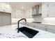 Modern kitchen with white cabinets, quartz countertops and a black island at 488 Broom Dr, Cumming, GA 30040