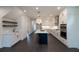 Modern kitchen with white cabinets, quartz countertops, and a large island at 488 Broom Dr, Cumming, GA 30040