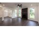 Bright living room features hardwood floors, fireplace, and multiple windows at 488 Broom Dr, Cumming, GA 30040