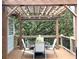 Outdoor dining on a spacious back deck, complete with a pergola strung with decorative lighting at 213 Moore Valley Way, Canton, GA 30115