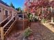 View of a backyard deck with a pergola during autumn surrounded by beautiful trees with fall colors at 213 Moore Valley Way, Canton, GA 30115
