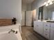 Well-lit bathroom featuring a soaking tub, white cabinets, and a clean, modern aesthetic for relaxation at 213 Moore Valley Way, Canton, GA 30115