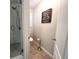 View of renovated bathroom with glass shower, tile flooring and updated fixtures at 213 Moore Valley Way, Canton, GA 30115