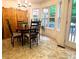 Bright dining area features a wooden table, chairs, and large windows for natural light at 213 Moore Valley Way, Canton, GA 30115