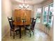 Inviting dining area featuring a round table set and abundant natural light through large windows at 213 Moore Valley Way, Canton, GA 30115