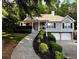 Beautiful home with meticulously landscaped front yard, covered porch, and attached two-car garage at 213 Moore Valley Way, Canton, GA 30115