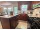 Bright kitchen featuring dark wood cabinets, granite countertops, and an adjacent dining area at 213 Moore Valley Way, Canton, GA 30115