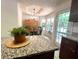 Bright kitchen with dark wood cabinets, granite countertops, and a view of the dining area at 213 Moore Valley Way, Canton, GA 30115