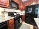 Functional kitchen featuring dark wood cabinets, granite countertops, and stainless appliances at 213 Moore Valley Way, Canton, GA 30115