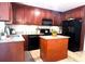 Beautiful kitchen featuring dark wood cabinets, granite countertops, and stainless appliances at 213 Moore Valley Way, Canton, GA 30115