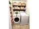 Convenient laundry room equipped with washer, dryer, wooden shelves and storage baskets at 213 Moore Valley Way, Canton, GA 30115