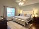 Cozy bedroom featuring a large bed with patterned bedding and ample natural light, perfect for relaxation at 213 Moore Valley Way, Canton, GA 30115