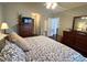 Comfortable bedroom featuring a well-appointed bed, dresser, and a peaceful ambiance, ideal for restful nights at 213 Moore Valley Way, Canton, GA 30115