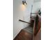 View of a staircase with carpeted steps, wood handrail, and black metal spindles, leading to the next level at 213 Moore Valley Way, Canton, GA 30115