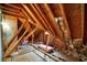 Unfinished attic space featuring exposed rafters, insulation, and OSB subflooring, offering potential for storage or future expansion at 205 Glenbrook Ln, Canton, GA 30115