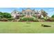 Gorgeous manor with an expansive lawn, manicured shrubs, and steps up to a covered terrace for relaxation at 205 Glenbrook Ln, Canton, GA 30115