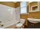 Standard bathroom with white tiled walls, a dark wood vanity, and window for natural light at 205 Glenbrook Ln, Canton, GA 30115
