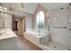 Bright primary bathroom with a soaking tub, glass enclosed shower and double sink vanity at 205 Glenbrook Ln, Canton, GA 30115