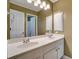 Bathroom with double sinks, a large mirror, and a doorway to a shower at 205 Glenbrook Ln, Canton, GA 30115
