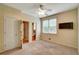 Bedroom featuring plush carpet, ceiling fan, and a window for natural light at 205 Glenbrook Ln, Canton, GA 30115