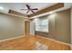 Bright bedroom with natural light, hardwood floors, recessed lighting, and a tray ceiling with a ceiling fan at 205 Glenbrook Ln, Canton, GA 30115