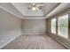 Spacious bedroom featuring plush carpet, ceiling fan, and a window for natural light at 205 Glenbrook Ln, Canton, GA 30115