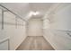 Spacious walk in closet with wall-mounted metal storage shelving and neutral carpeting at 205 Glenbrook Ln, Canton, GA 30115