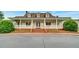 Attractive clubhouse with a welcoming porch, columns and a brick stair entrance that gives inviting curb appeal at 205 Glenbrook Ln, Canton, GA 30115