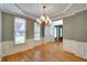 Dining area showcases hardwood flooring, modern chandelier, and windows offering ample natural light at 205 Glenbrook Ln, Canton, GA 30115