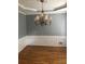 Elegant dining room featuring hardwood floors, wainscoting, and a stunning chandelier at 205 Glenbrook Ln, Canton, GA 30115