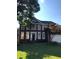 Brick two-story house with a landscaped lawn at 205 Glenbrook Ln, Canton, GA 30115