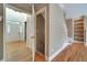 Inviting foyer with gleaming hardwood floors, staircase with white risers, and a clear view into the home at 205 Glenbrook Ln, Canton, GA 30115