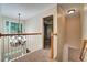 Hallway with plush carpet, wood railing, and open view to room with ceiling fan at 205 Glenbrook Ln, Canton, GA 30115