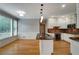 Bright kitchen with white cabinetry, granite countertops, stainless steel appliances, and hardwood floors at 205 Glenbrook Ln, Canton, GA 30115