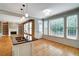 Bright kitchen featuring a large window, stainless steel sink, granite countertop, and hardwood flooring at 205 Glenbrook Ln, Canton, GA 30115
