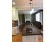 Open kitchen with granite island and view of living room at 205 Glenbrook Ln, Canton, GA 30115