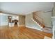 Open-concept living room with hardwood floors seamlessly connecting to kitchen area at 205 Glenbrook Ln, Canton, GA 30115