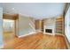 Spacious living room featuring hardwood flooring, a fireplace, built-in bookshelves and natural light at 205 Glenbrook Ln, Canton, GA 30115