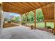 Relaxing covered patio space with concrete flooring and backyard views for entertaining friends and Gathering at 205 Glenbrook Ln, Canton, GA 30115