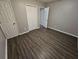 Spacious bedroom with wood-look floors and an adjacent bathroom at 3445 Mell Pl, Clarkston, GA 30021