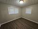 Well-lit bedroom featuring wood-look floors and neutral walls at 3445 Mell Pl, Clarkston, GA 30021