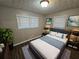 Cozy bedroom with a comfortable bed, and two windows at 3445 Mell Pl, Clarkston, GA 30021
