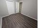 Spacious bedroom featuring wood-look floors and ample closet space at 3445 Mell Pl, Clarkston, GA 30021