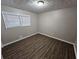 Simple bedroom with wood-look floors and neutral walls at 3445 Mell Pl, Clarkston, GA 30021