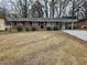 Brick ranch house with carport and a yard at 3445 Mell Pl, Clarkston, GA 30021