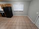 Kitchen with tile floor, wood cabinets, and black appliances at 3445 Mell Pl, Clarkston, GA 30021