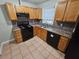 Well-equipped kitchen with wood cabinets and black appliances at 3445 Mell Pl, Clarkston, GA 30021