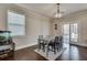 Casual dining area features a table with four chairs and access to back deck at 6710 Country Lake Rd, Cumming, GA 30041