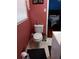 Simple bathroom with white toilet and coral walls at 2479 Kingsland Dr, Dunwoody, GA 30360